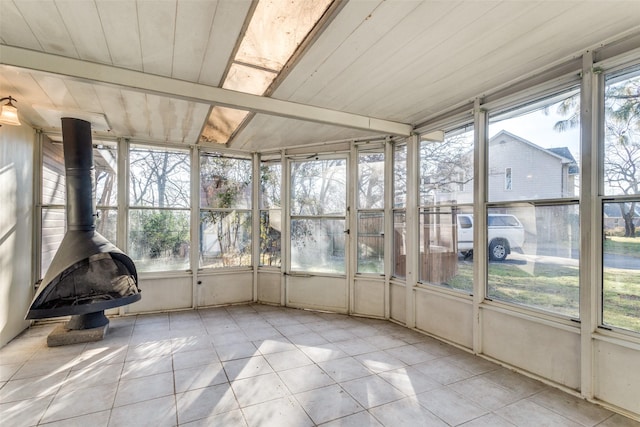 unfurnished sunroom with wooden ceiling and a wood stove