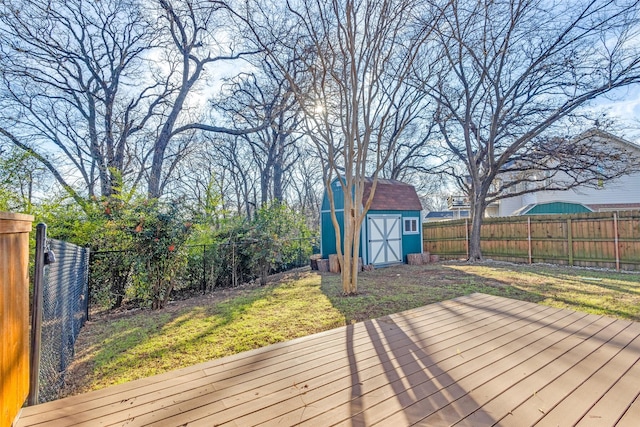 wooden terrace with a lawn and a storage unit