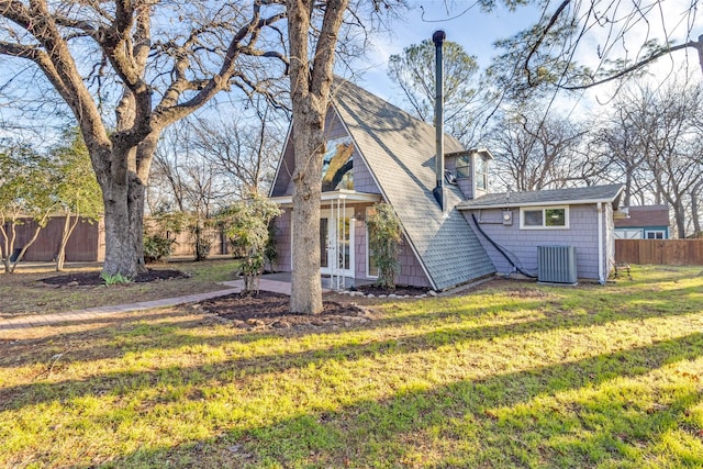 exterior space featuring central AC, french doors, and a yard