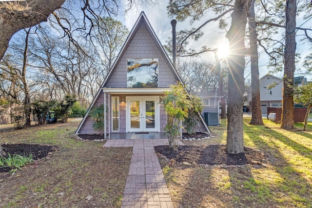 view of front of home with central AC unit and french doors