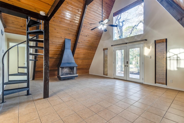 interior space featuring light tile patterned floors, wooden ceiling, a wood stove, french doors, and beam ceiling