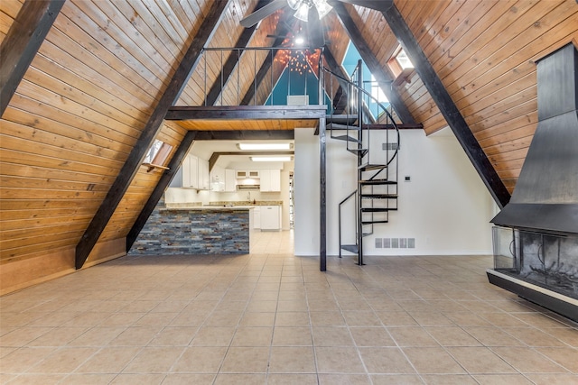 additional living space featuring ceiling fan, beamed ceiling, high vaulted ceiling, light tile patterned floors, and wooden ceiling