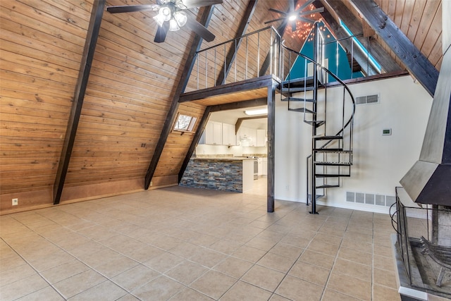 interior space featuring wooden ceiling, light tile patterned flooring, beam ceiling, and high vaulted ceiling