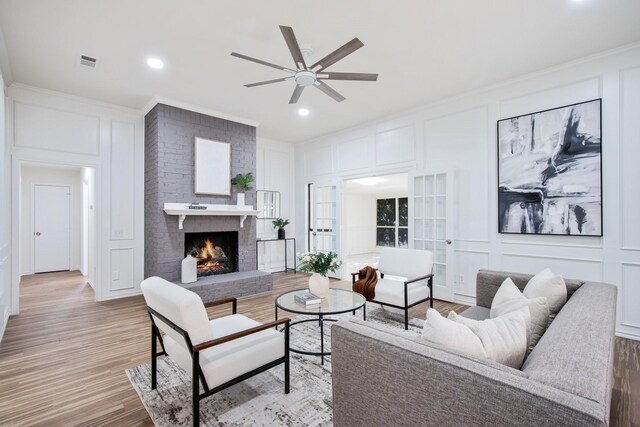 kitchen featuring backsplash, black appliances, sink, white cabinets, and island range hood