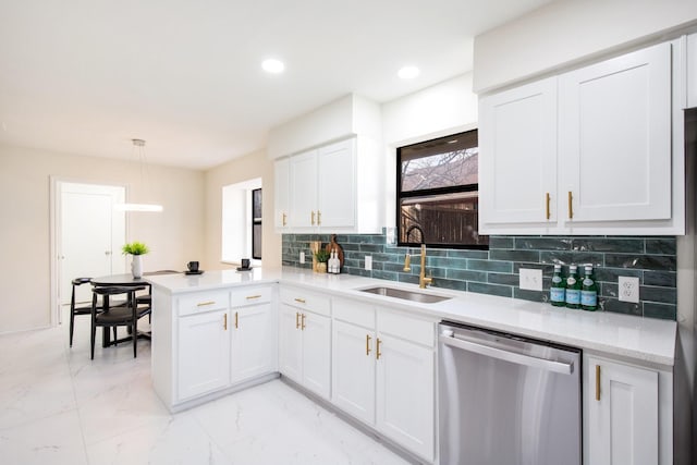 kitchen featuring pendant lighting, white cabinetry, sink, kitchen peninsula, and stainless steel dishwasher