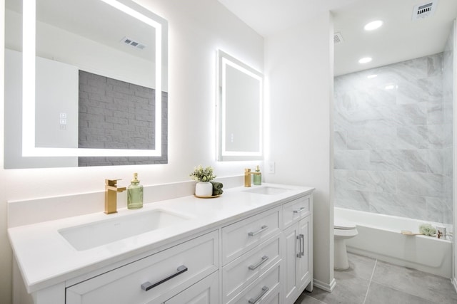 full bathroom featuring toilet, tiled shower / bath combo, tile patterned floors, and vanity