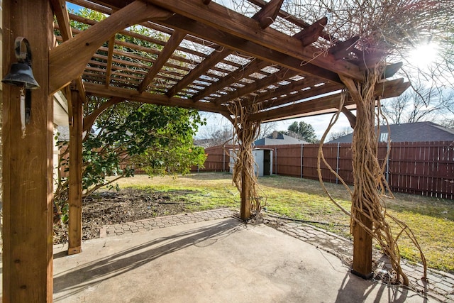 view of patio / terrace with a pergola and a shed