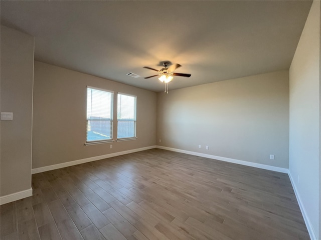 spare room featuring ceiling fan and light hardwood / wood-style floors