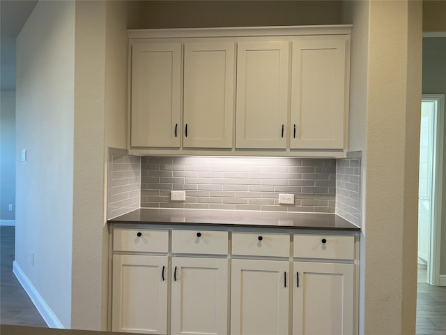 kitchen featuring white cabinets and decorative backsplash