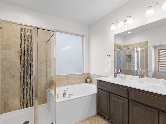 bathroom featuring a garden tub, a shower stall, a sink, and tile patterned floors