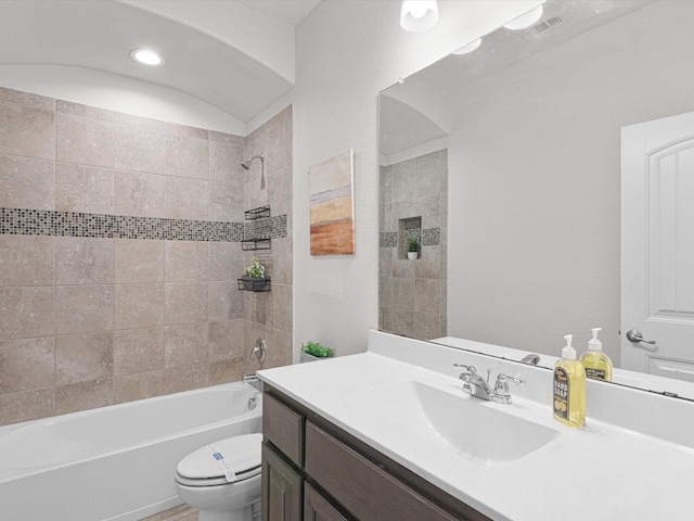 bathroom with visible vents, tub / shower combination, vanity, and toilet