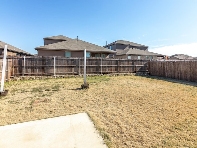 view of yard featuring a patio area and a fenced backyard