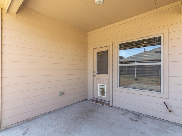 entrance to property featuring a patio