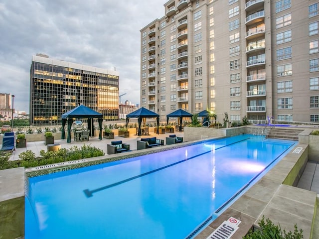 view of swimming pool featuring a patio area and a gazebo