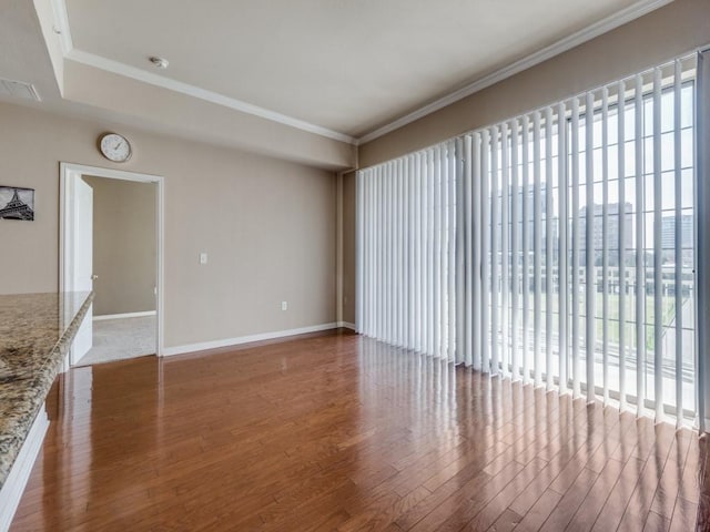 unfurnished living room with crown molding and hardwood / wood-style flooring