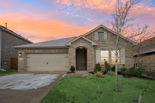 view of front of home with a front lawn and a garage