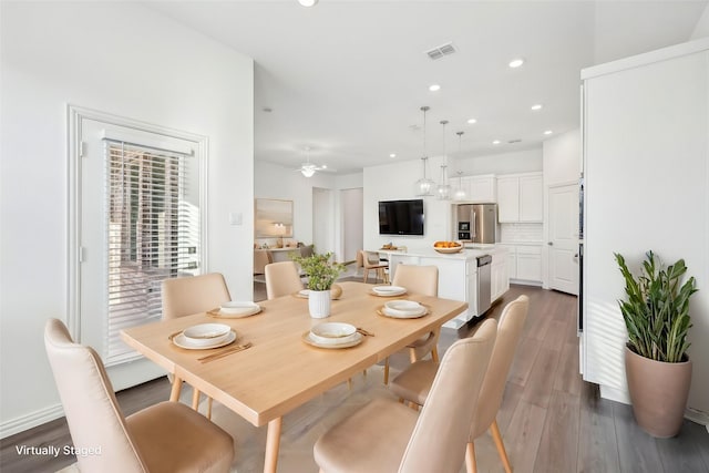 dining room featuring dark hardwood / wood-style floors and ceiling fan