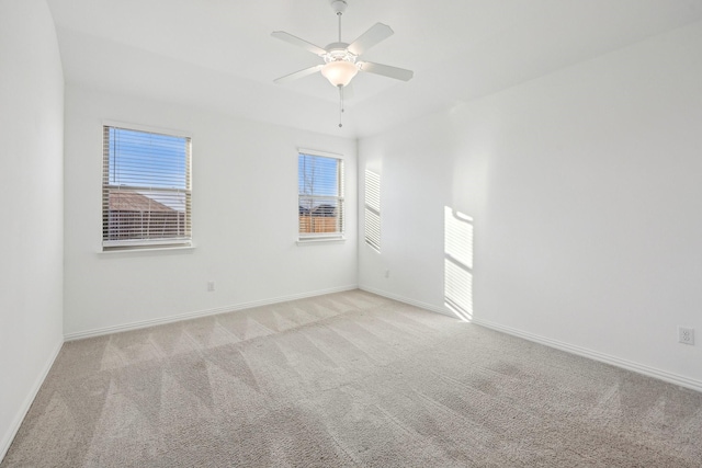 unfurnished room featuring light colored carpet and ceiling fan