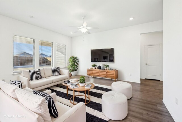 unfurnished living room with ceiling fan, dark wood-type flooring, and sink