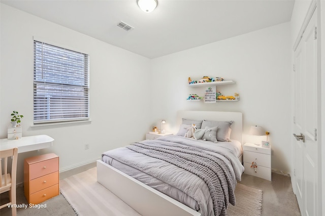 bedroom featuring light carpet