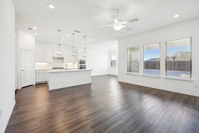 unfurnished living room with ceiling fan, sink, and dark hardwood / wood-style flooring