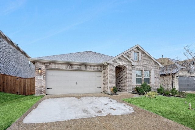 view of front of house with a garage and a front lawn