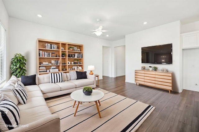 living room featuring hardwood / wood-style floors and ceiling fan