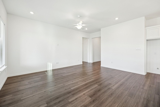 unfurnished room featuring ceiling fan and dark hardwood / wood-style flooring