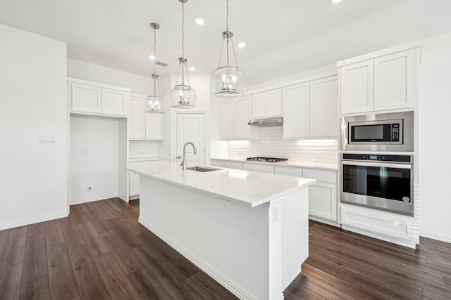 kitchen with sink, a center island with sink, white cabinets, and appliances with stainless steel finishes