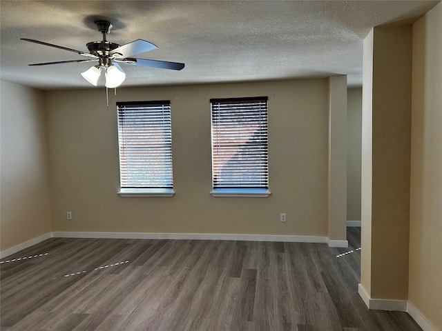 unfurnished room featuring ceiling fan, a textured ceiling, and dark hardwood / wood-style flooring