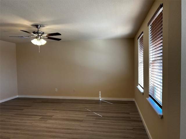 spare room featuring ceiling fan and dark hardwood / wood-style flooring