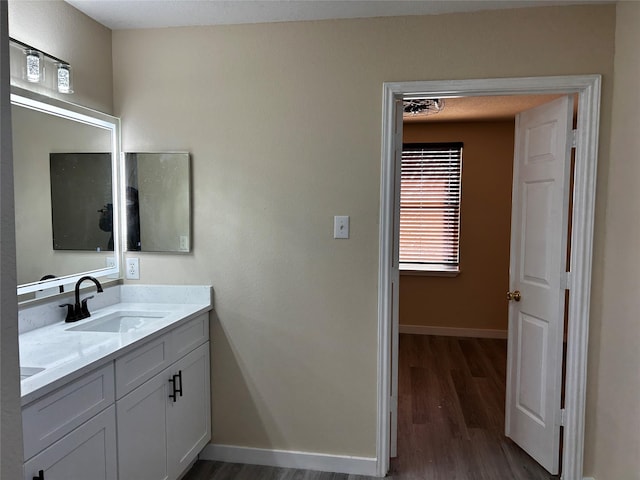 bathroom featuring hardwood / wood-style flooring and vanity