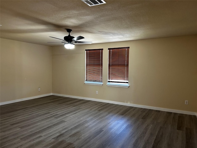 spare room featuring ceiling fan, a textured ceiling, and dark hardwood / wood-style flooring