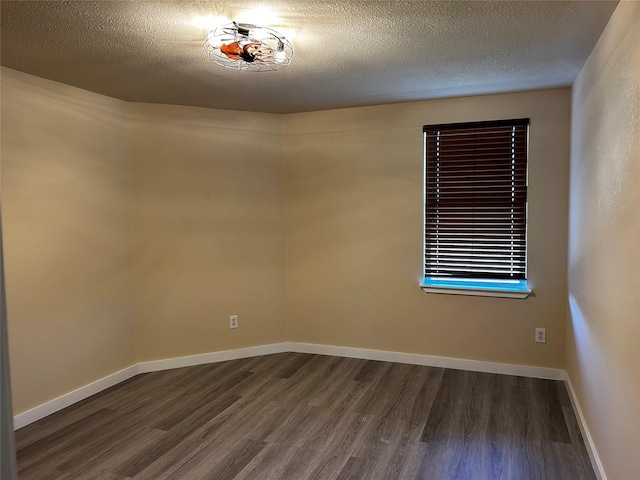 unfurnished room featuring a textured ceiling and dark hardwood / wood-style flooring