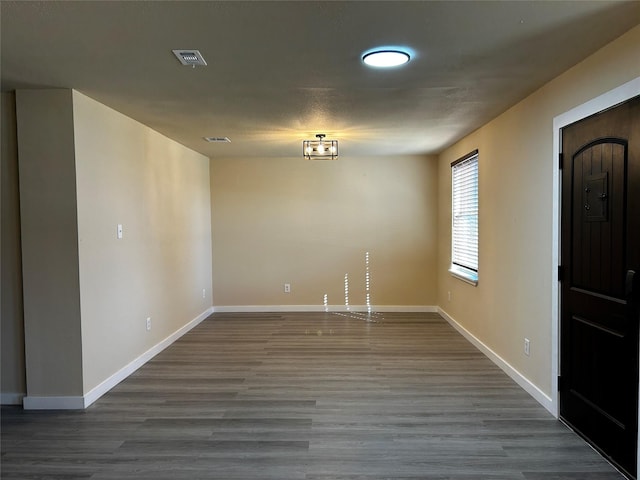 unfurnished room featuring hardwood / wood-style flooring