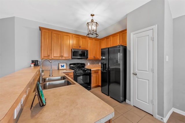 kitchen with decorative light fixtures, a notable chandelier, black appliances, sink, and light tile patterned floors