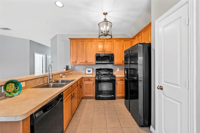 kitchen with sink, pendant lighting, black appliances, and kitchen peninsula