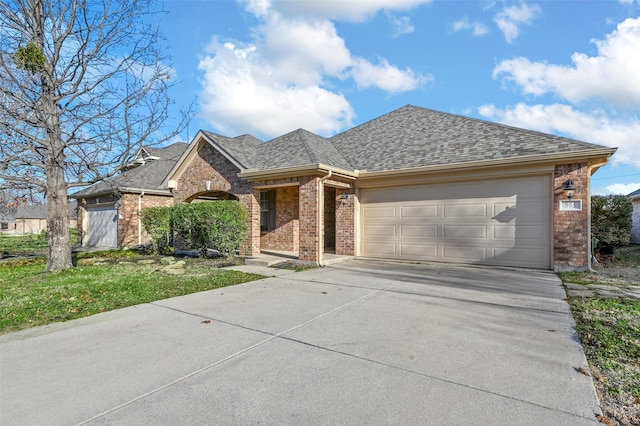 view of front of home with a front yard and a garage