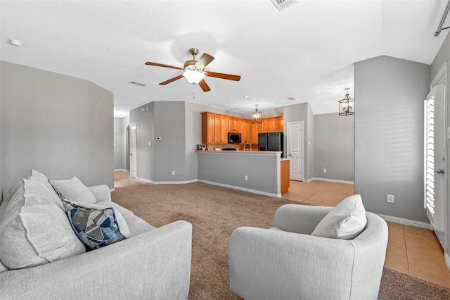 living room featuring light colored carpet, lofted ceiling, and ceiling fan with notable chandelier