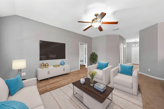 living room with ceiling fan, light colored carpet, and lofted ceiling