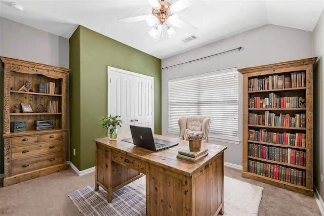 office space featuring light carpet, ceiling fan, and lofted ceiling