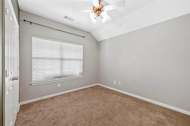 carpeted empty room with ceiling fan and lofted ceiling