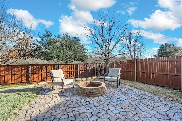 view of patio / terrace featuring an outdoor fire pit