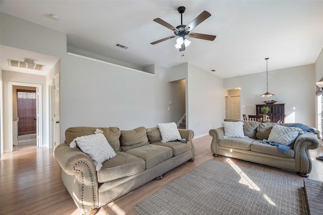 living room featuring ceiling fan and hardwood / wood-style floors