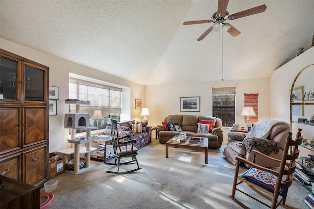 carpeted living room featuring a textured ceiling, ceiling fan, and a wealth of natural light