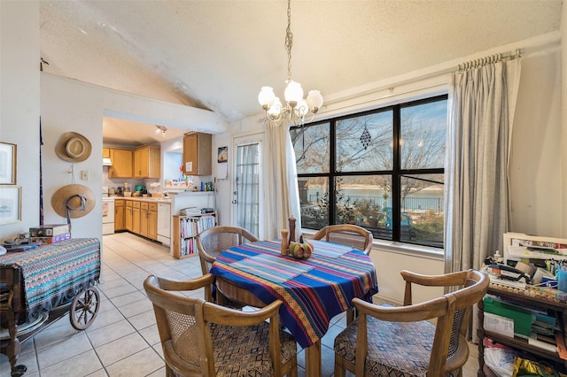 dining area featuring a textured ceiling, light tile patterned floors, an inviting chandelier, and vaulted ceiling