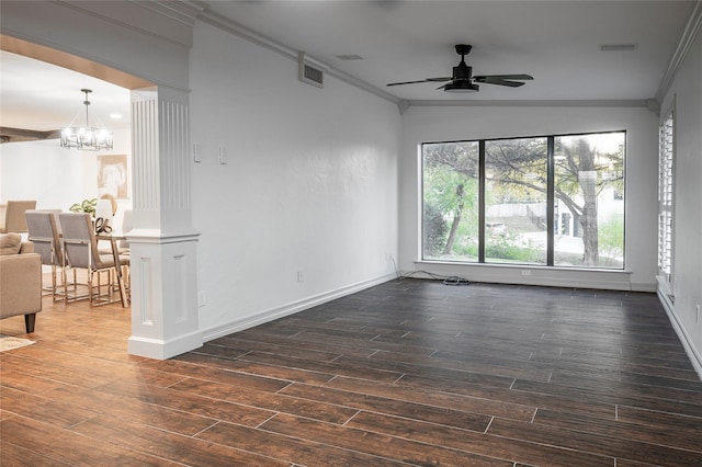 empty room featuring crown molding, dark wood-type flooring, and ceiling fan with notable chandelier