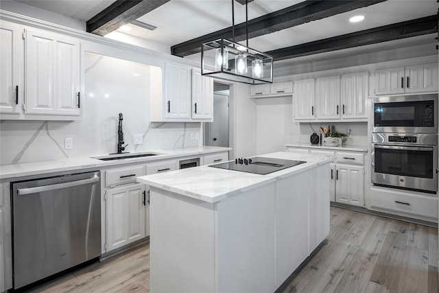 kitchen featuring sink, white cabinetry, stainless steel dishwasher, a kitchen island, and black electric stovetop