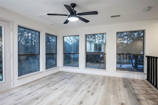 unfurnished sunroom featuring ceiling fan