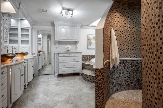 kitchen with white cabinetry and crown molding